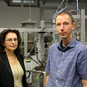 Two person standing in front of a production system